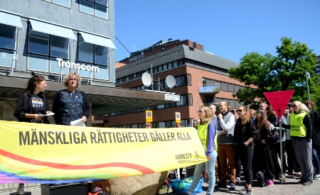 Louise Bergetoft från Queer Amnesty Stockholm talar och Anna Lindenfors, generalsekreterare för svenska Amnesty, tolkar till engelska. Amnesty kräver att övergreppen i Tjetjenien utreds omedelbart och att de ansvariga ställs inför rätta