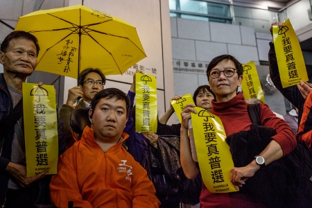 Medlemmar från olika politiska partier håller upp banderoller vid en demonstration i Hongkong i slutet av mars. Paraplyrörelsen 2014 ökade stadens politiska engagemang, men splittrade också demokratiaktivister.